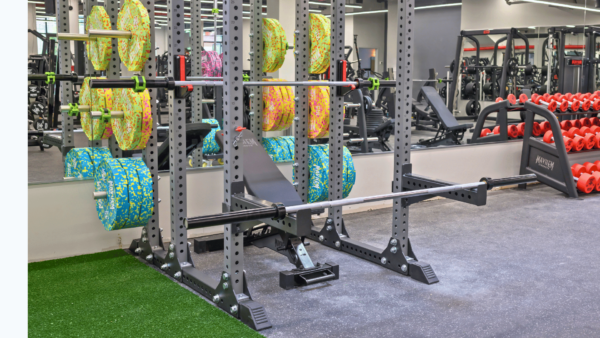 Colorful neon fleck bumper plates stacked for workout at a gym